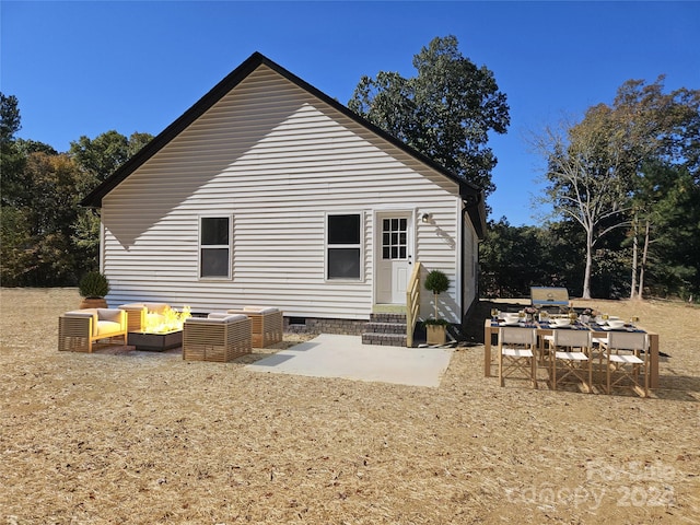 back of property with a patio area and an outdoor living space