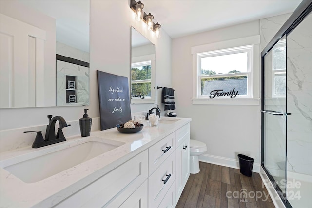 full bathroom with vanity, toilet, hardwood / wood-style flooring, and enclosed tub / shower combo