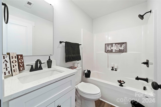 full bathroom featuring vanity, shower / washtub combination, hardwood / wood-style flooring, and toilet