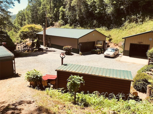 exterior space with a garage and an outdoor structure