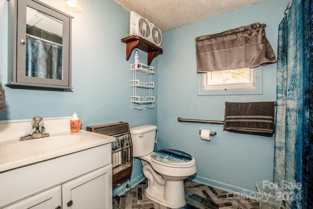 bathroom featuring vanity, toilet, and a textured ceiling