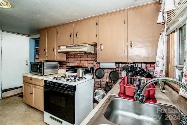 kitchen with sink and white range with gas cooktop