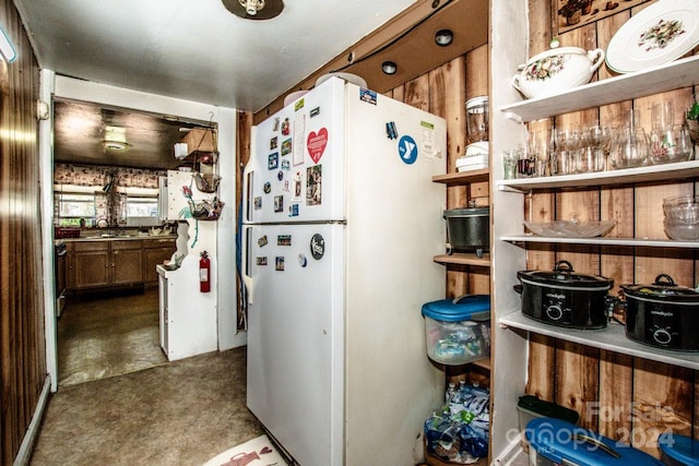 kitchen with sink, stainless steel stove, and white refrigerator