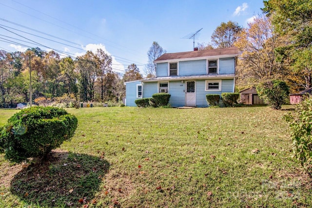 rear view of property featuring a yard