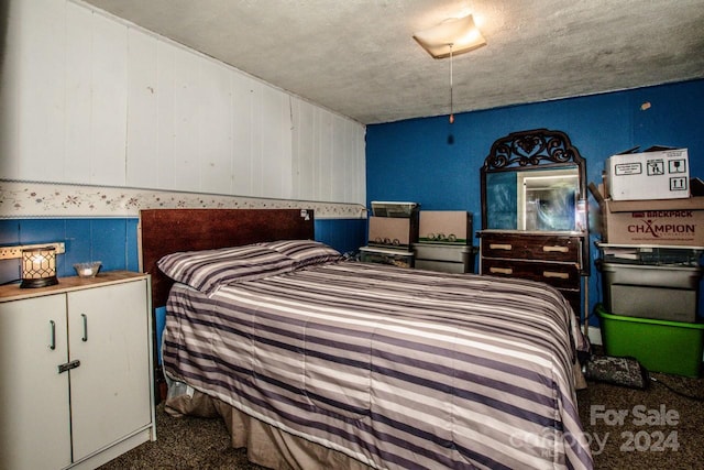 bedroom featuring dark carpet