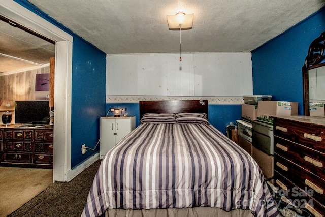 carpeted bedroom featuring a textured ceiling