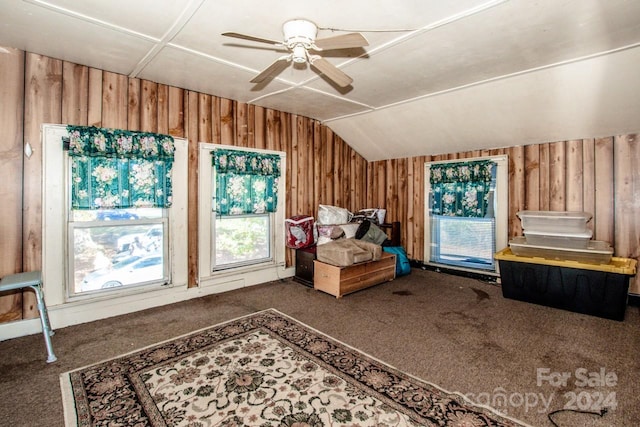 misc room featuring a wealth of natural light, vaulted ceiling, and dark carpet