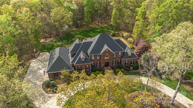 birds eye view of property with a wooded view