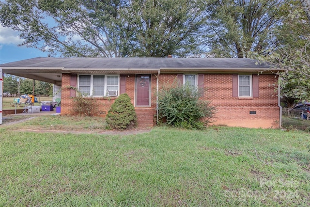 view of front of property with a front lawn and a carport