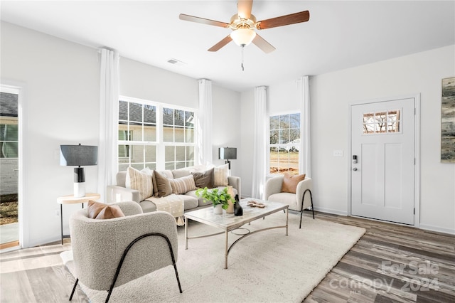 living room featuring wood-type flooring and ceiling fan