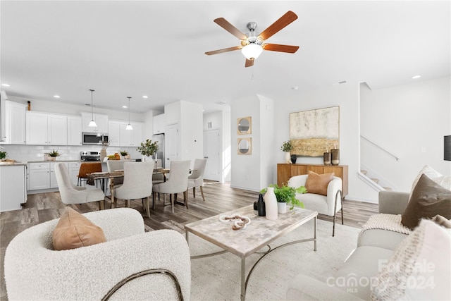 living room with hardwood / wood-style floors and ceiling fan