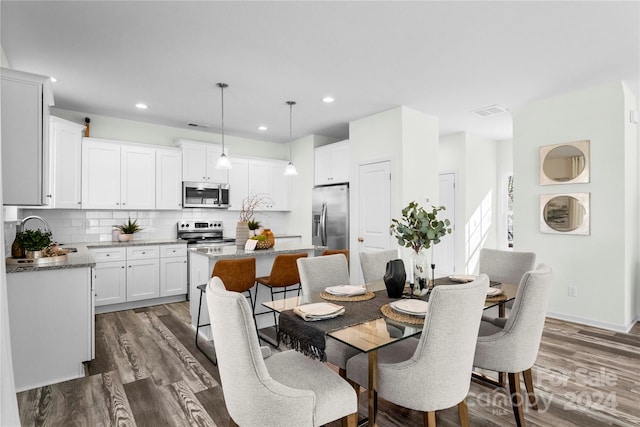 dining room featuring dark hardwood / wood-style floors and sink