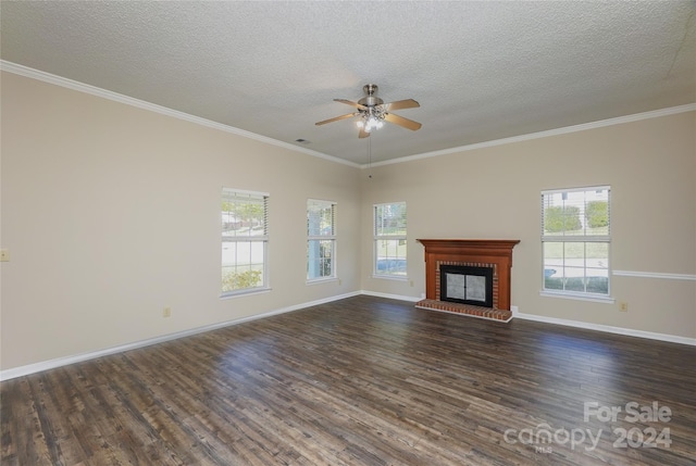 unfurnished living room with a fireplace, crown molding, dark hardwood / wood-style flooring, and a textured ceiling