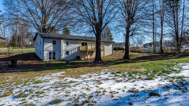 snow covered property with a wooden deck