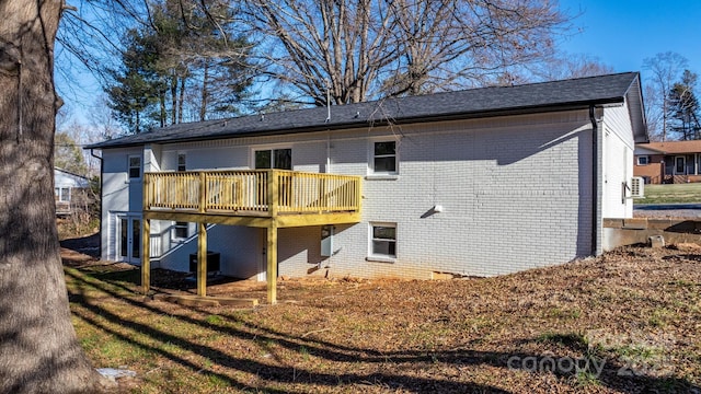 rear view of house featuring central AC and a deck