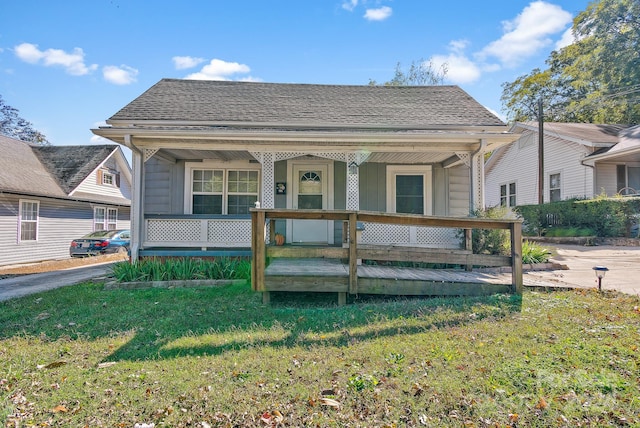 bungalow-style home with a front lawn