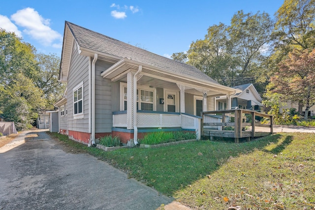 bungalow with a porch and a front yard