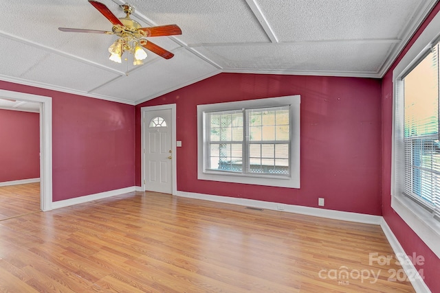 entrance foyer with a textured ceiling, ceiling fan, a wealth of natural light, and light hardwood / wood-style flooring