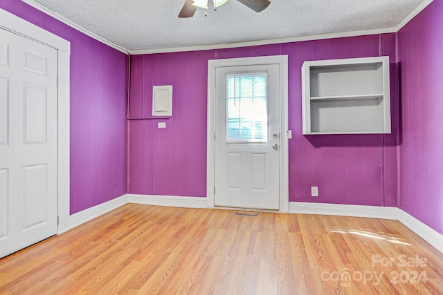 foyer with ornamental molding, ceiling fan, hardwood / wood-style floors, and a textured ceiling