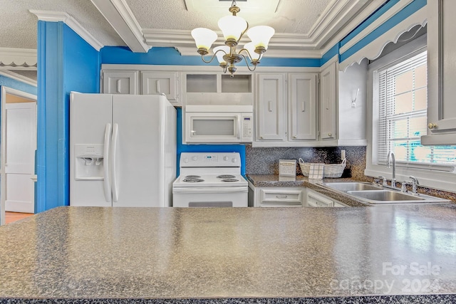 kitchen with white appliances, sink, a chandelier, ornamental molding, and decorative light fixtures