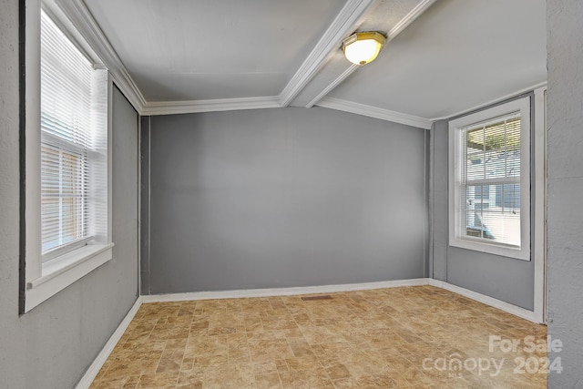 unfurnished room featuring beam ceiling and ornamental molding