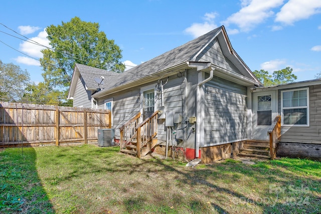 back of property with a yard and cooling unit