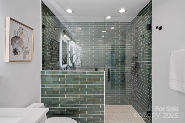 bathroom featuring toilet, an enclosed shower, and vanity