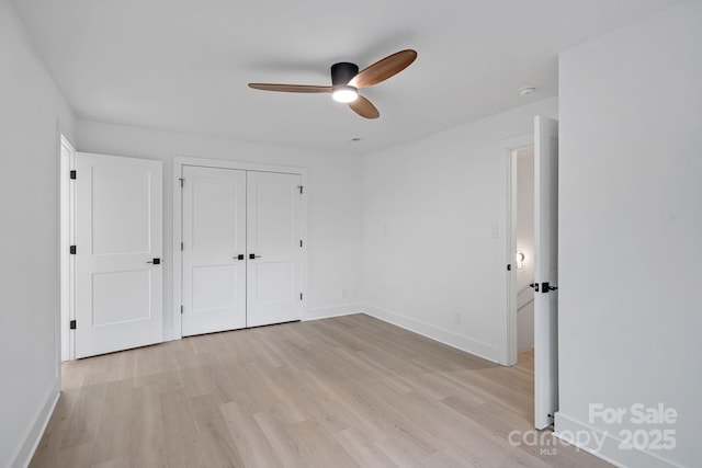 unfurnished bedroom featuring a closet, ceiling fan, and light wood-type flooring