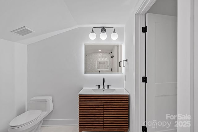 bathroom featuring toilet, a shower, vanity, and lofted ceiling