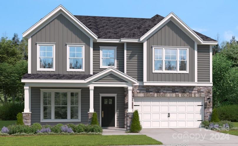 craftsman house featuring a garage and a front lawn