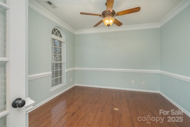 unfurnished room with dark wood-type flooring, visible vents, and crown molding