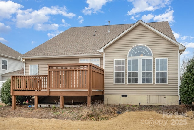 rear view of property featuring crawl space, a shingled roof, and a wooden deck