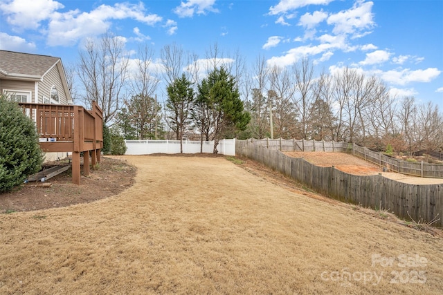 view of yard with a fenced backyard and a deck