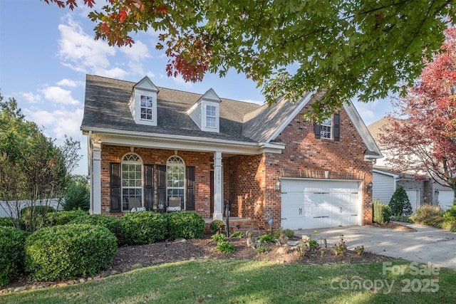 view of front of home with brick siding, a garage, and driveway