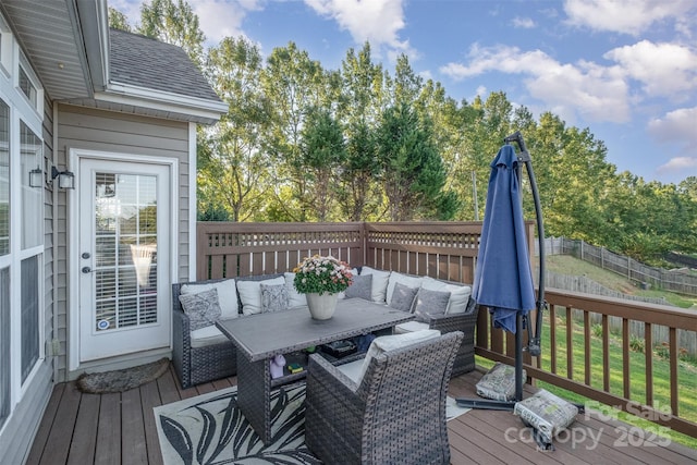 deck featuring outdoor lounge area and fence