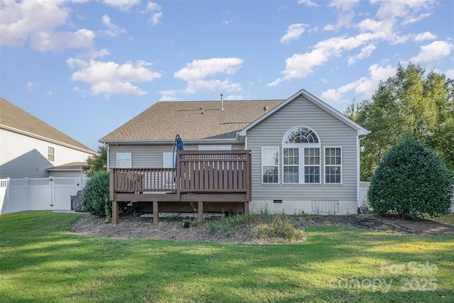 back of house featuring a shingled roof, fence, a deck, a yard, and crawl space