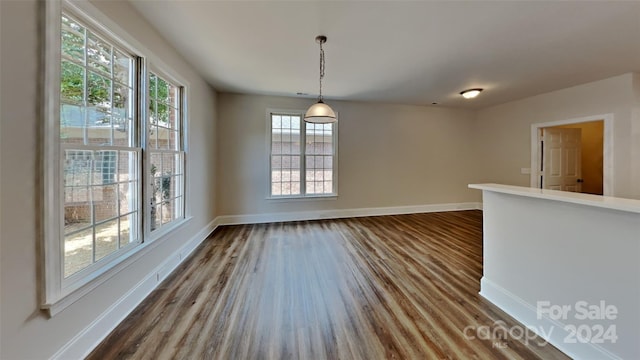 unfurnished dining area with hardwood / wood-style floors