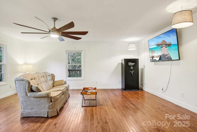 living room with hardwood / wood-style floors and ceiling fan