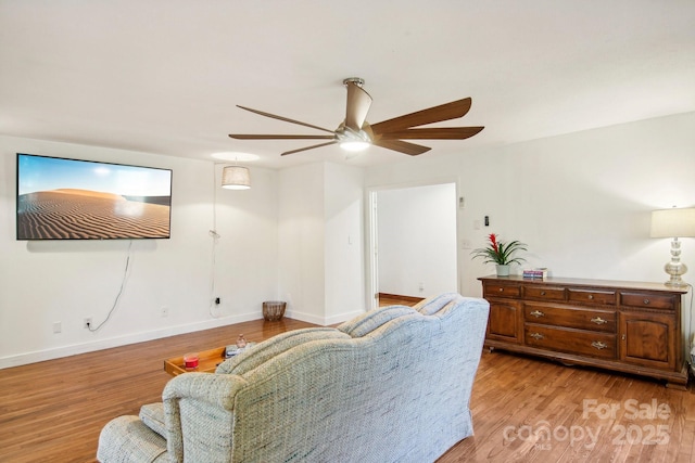 living room featuring ceiling fan and light hardwood / wood-style flooring