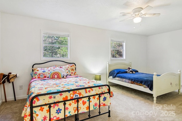 carpeted bedroom featuring multiple windows and ceiling fan