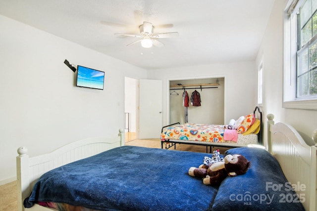 bedroom with carpet flooring, ceiling fan, and a closet