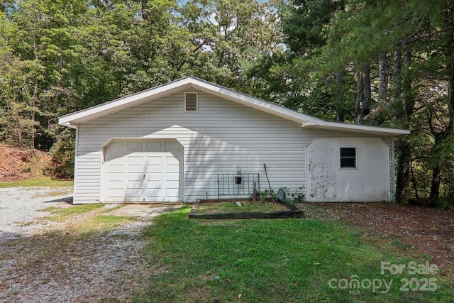 view of home's exterior with a garage and an outdoor structure