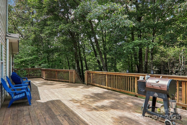 wooden terrace featuring a grill