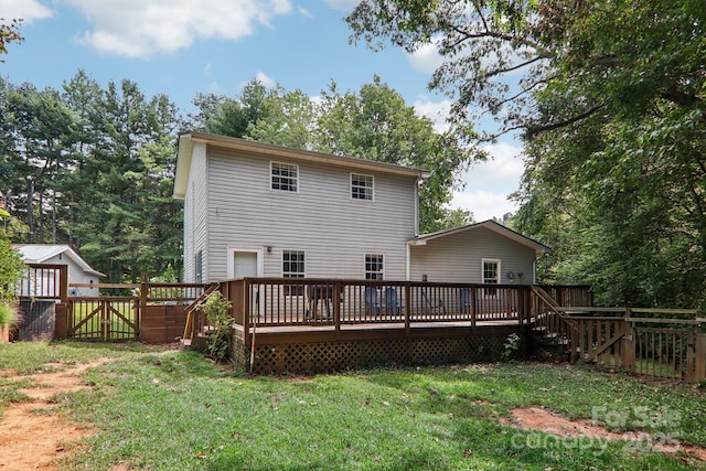 back of house with a lawn and a wooden deck