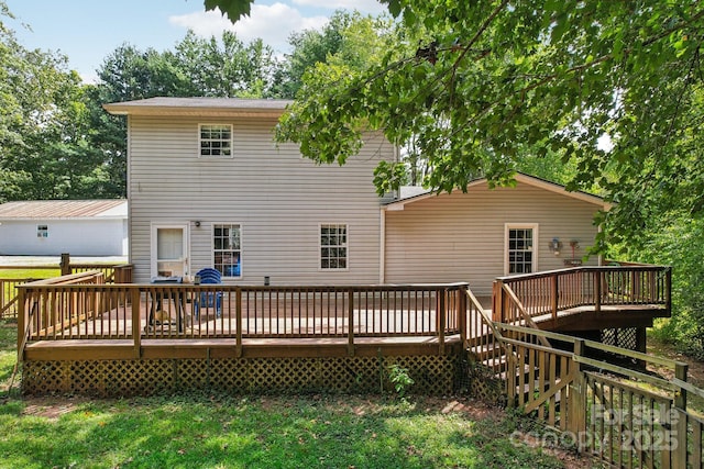 rear view of property with a wooden deck