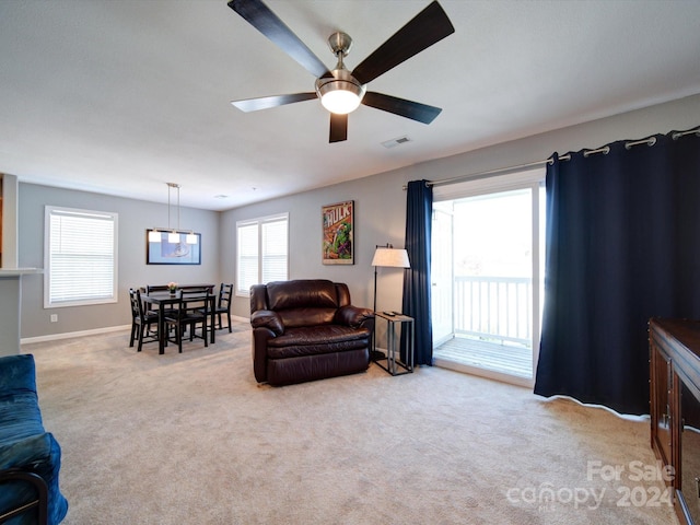 carpeted living room with a healthy amount of sunlight and ceiling fan