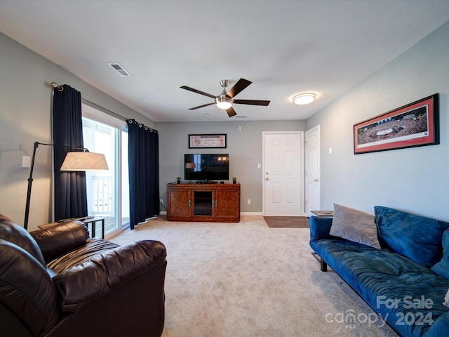 living room with light carpet and ceiling fan