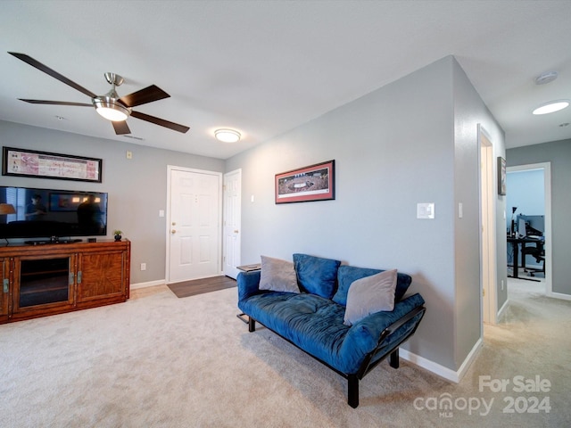 carpeted living room with ceiling fan