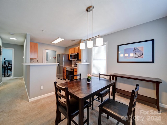 dining room featuring light colored carpet