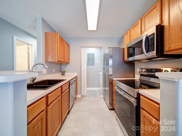 kitchen featuring stainless steel appliances, electric panel, sink, and light tile patterned flooring